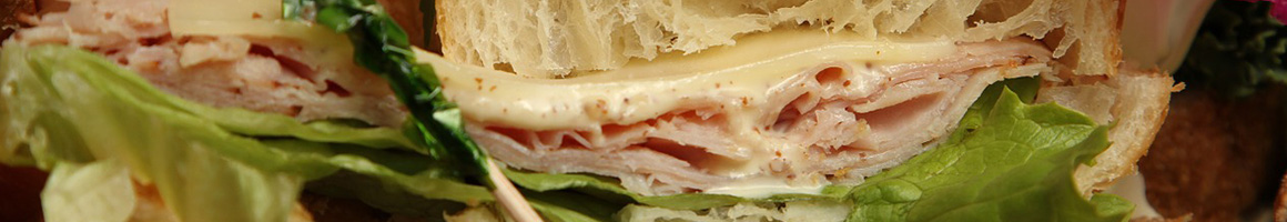 Eating Sandwich Cafe at Moxie's Too cafe & Deli restaurant in Tampa, FL.